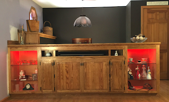 Custom-built oak cabinet for TV on a lift